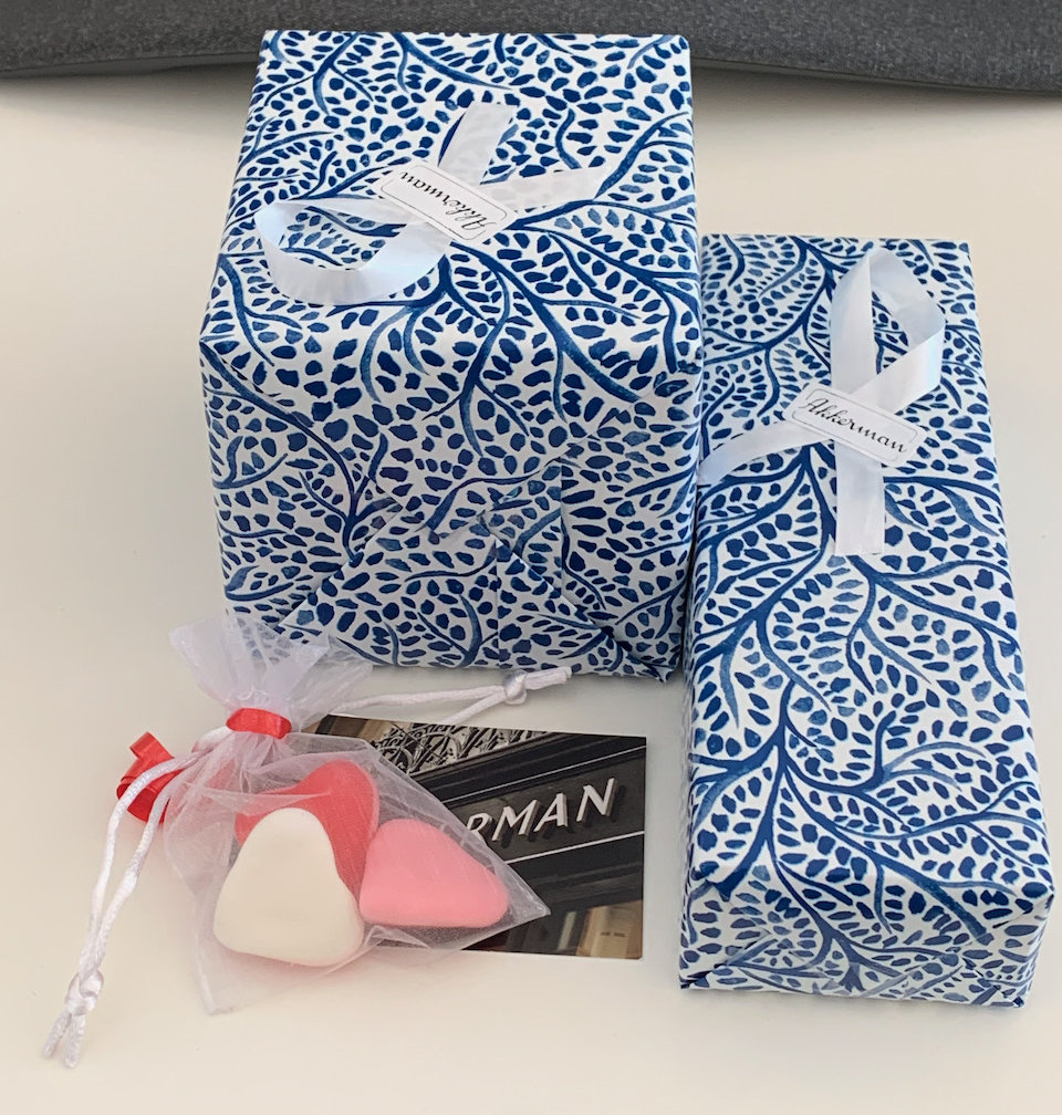 Two gift-wrapped packages together with a small bag of sweets