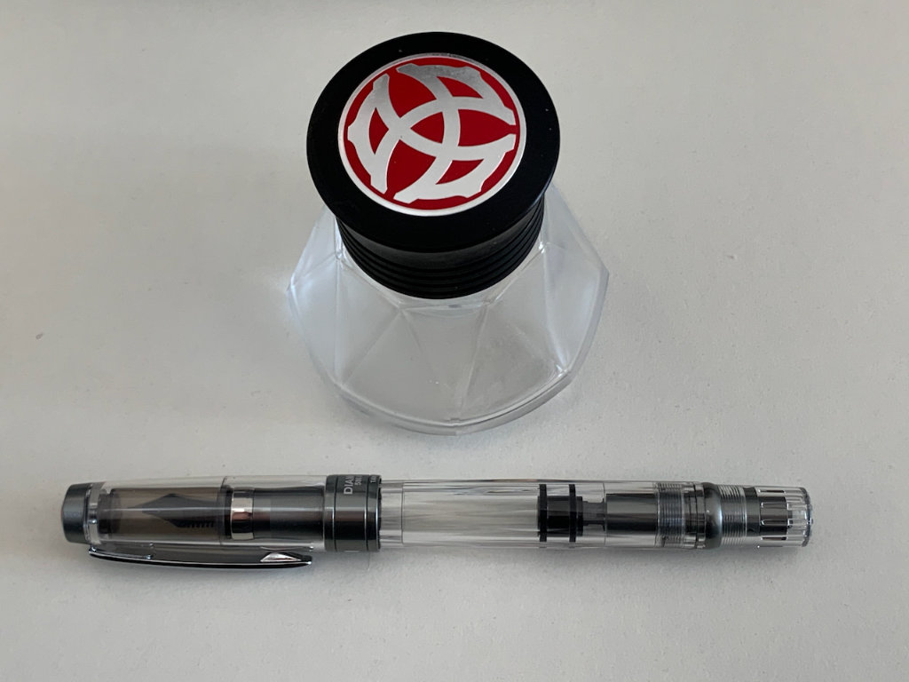 Fountain pen with empty ink bottle